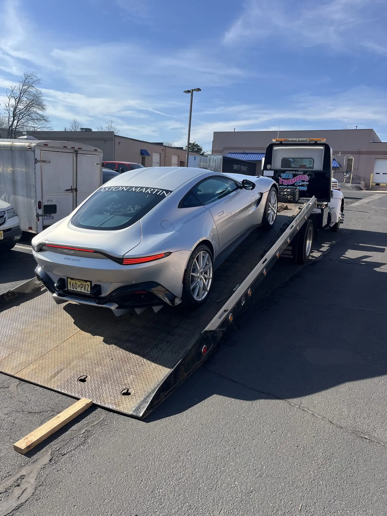 An Aston Martin secured on the flatbed
