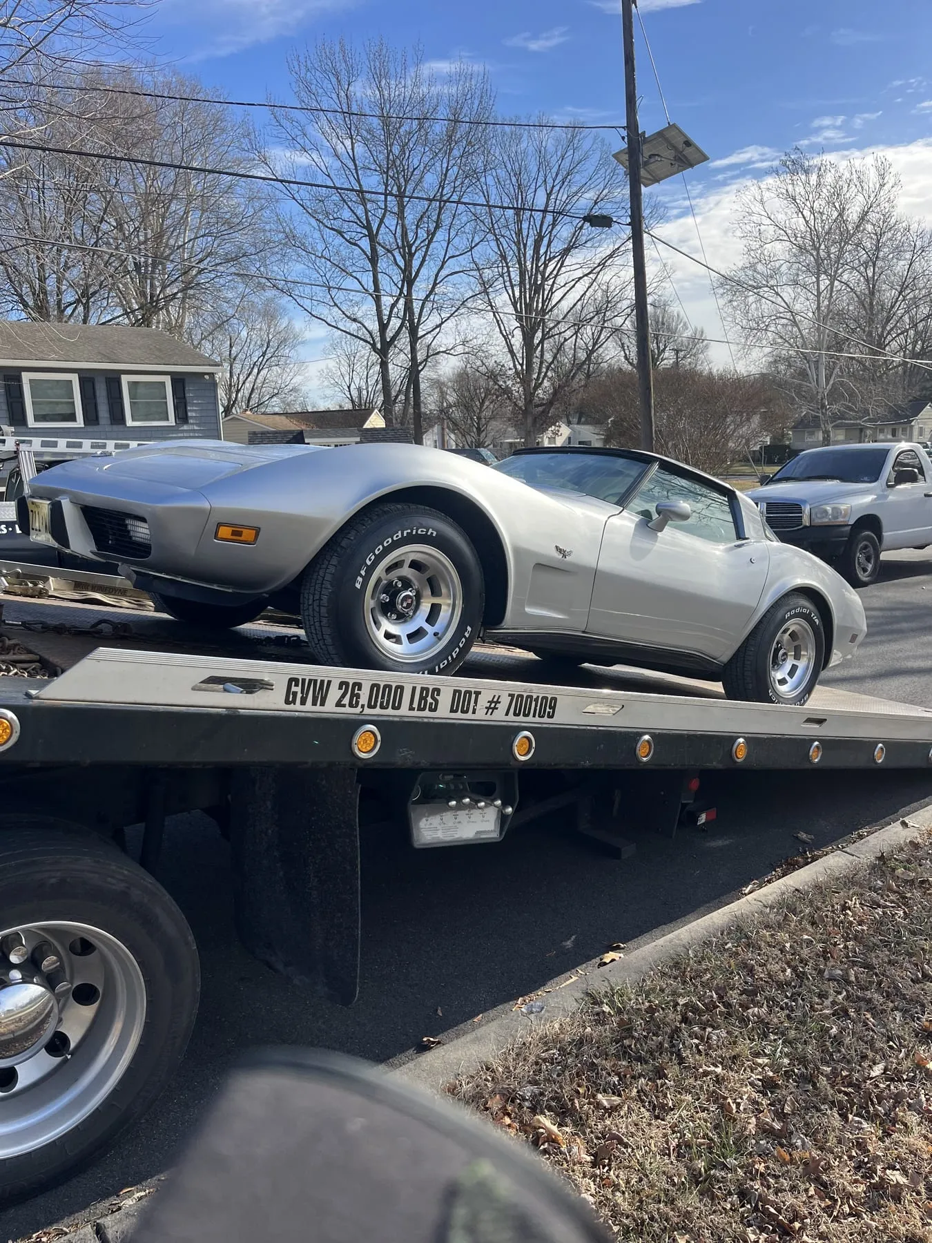 A Chevrolet Corvette loaded on the flatbed